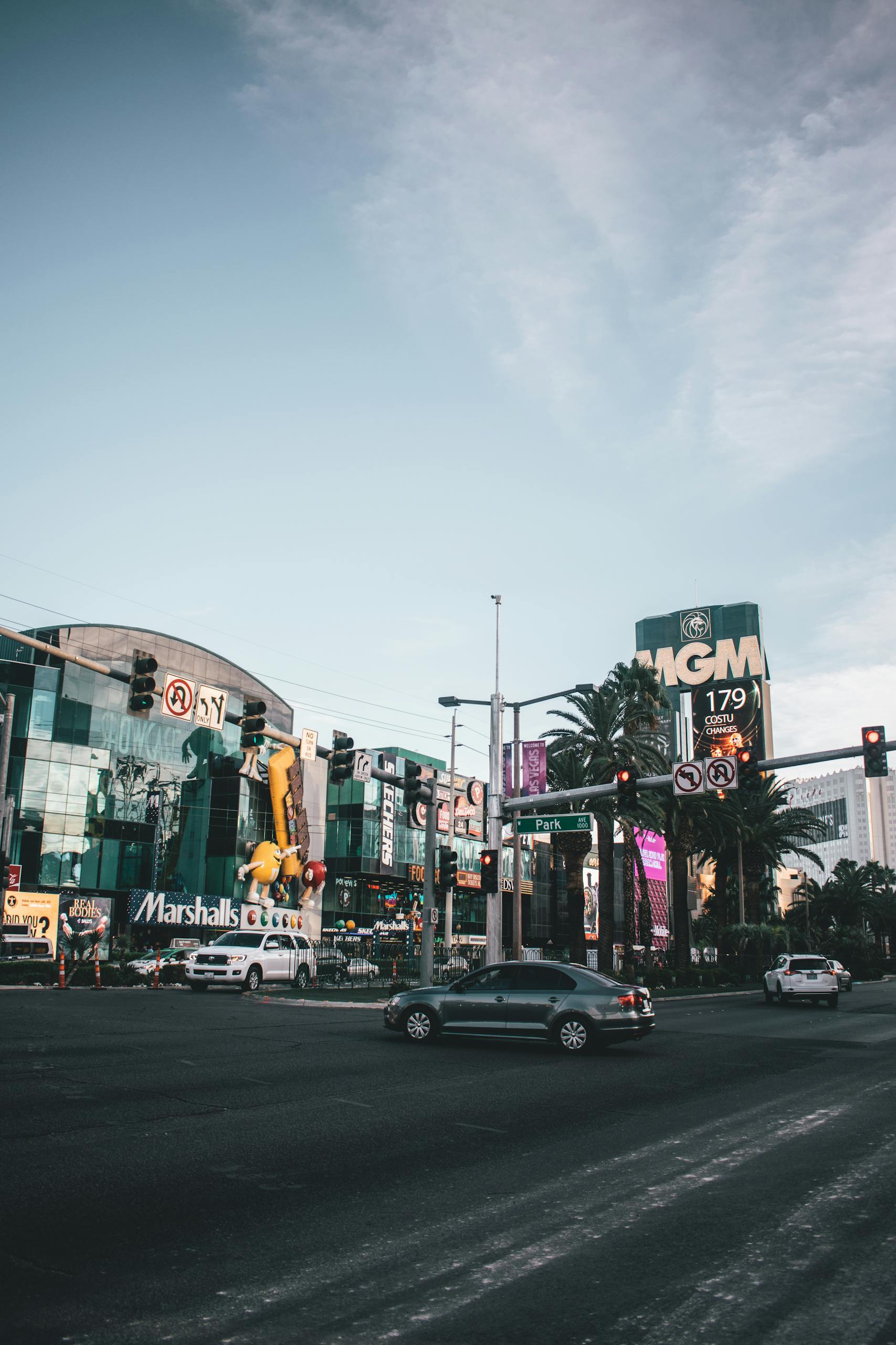 Vibrant street scene of Las Vegas Strip featuring MGM Grand Hotel and nearby attractions at dusk.